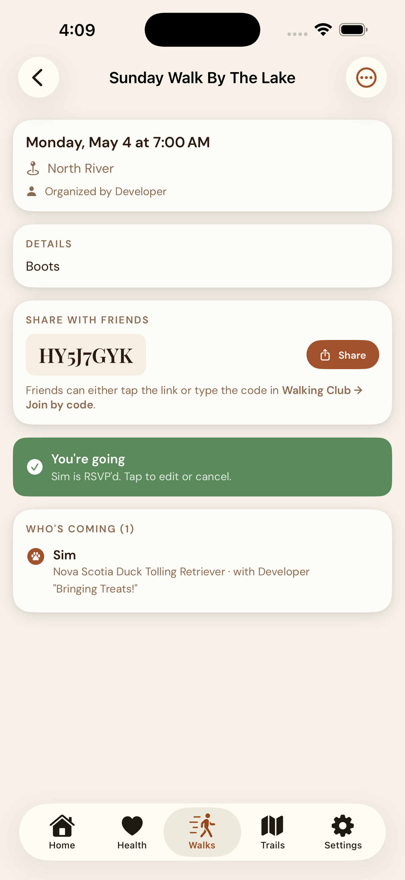EmberPaws on phone B — the friend tapped the iMessage link and the app opened straight to the same walk. A green 'You're going' pill confirms their RSVP, and the attendee list now includes their dog.